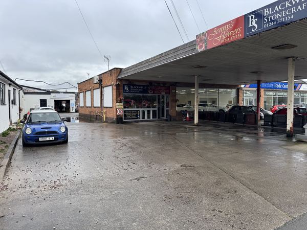 Approach to DJ Motors from Parkgate Road, showing the left entrance past the florist