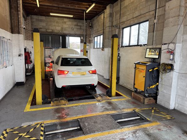 MOT testing bay at DJ Motors with vehicle on the ramp and Crypton diagnostic equipment